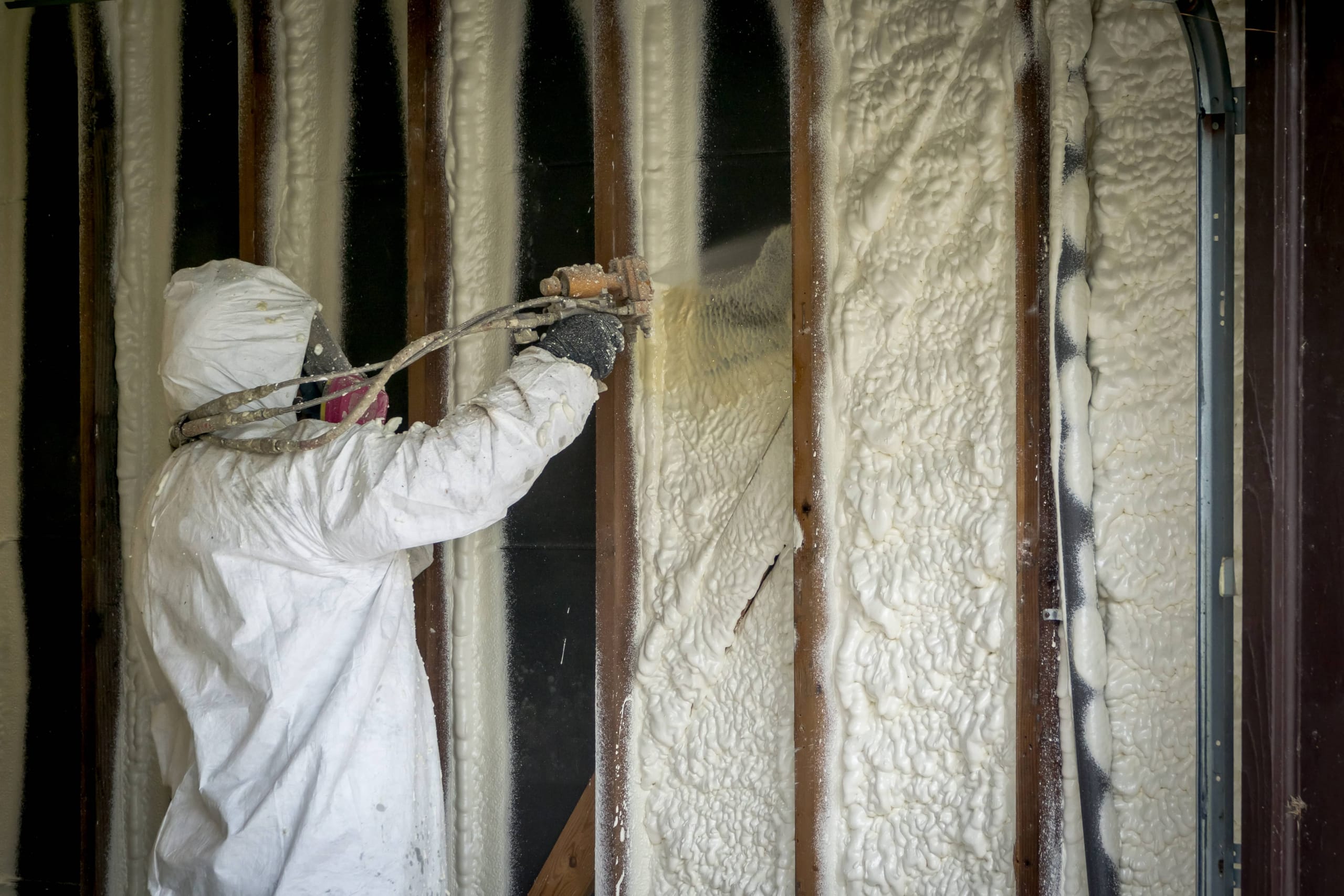 Spray foam insulation being applied to attic rafters in Los Angeles